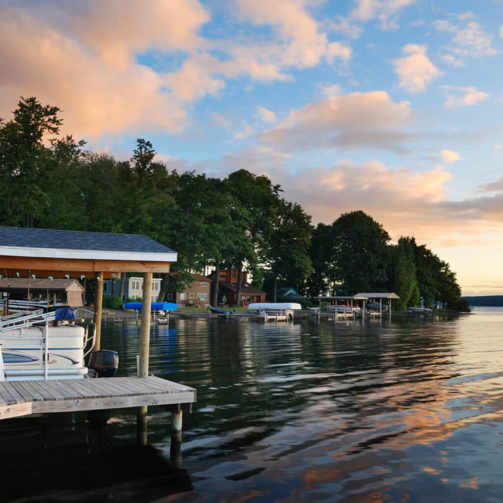 Lake with docks and boats next to houses