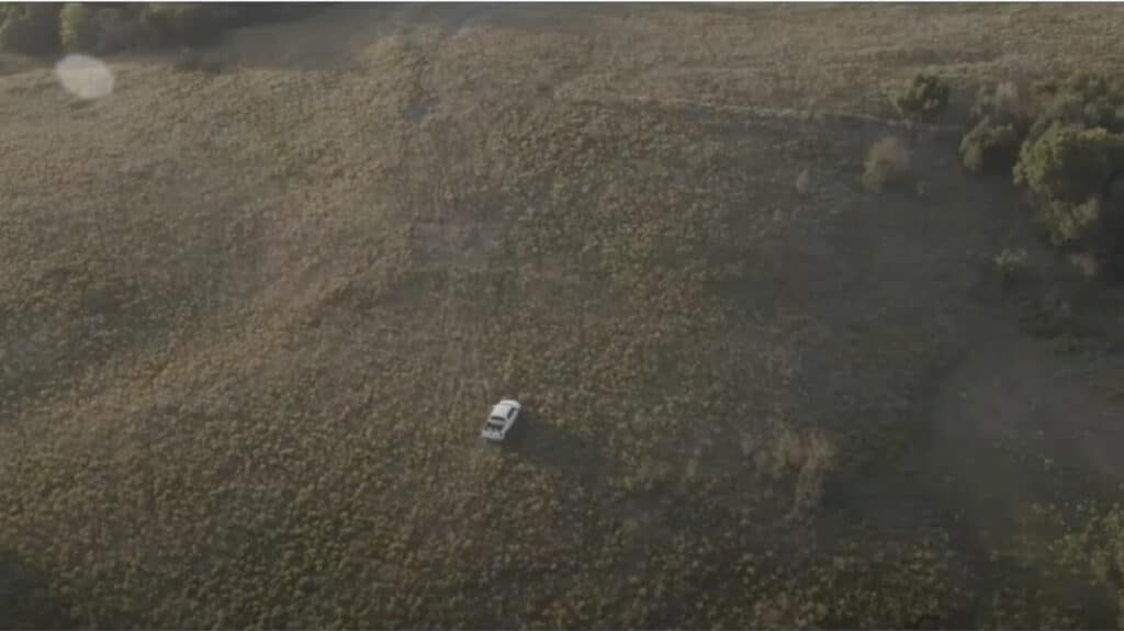 White truck driving through field